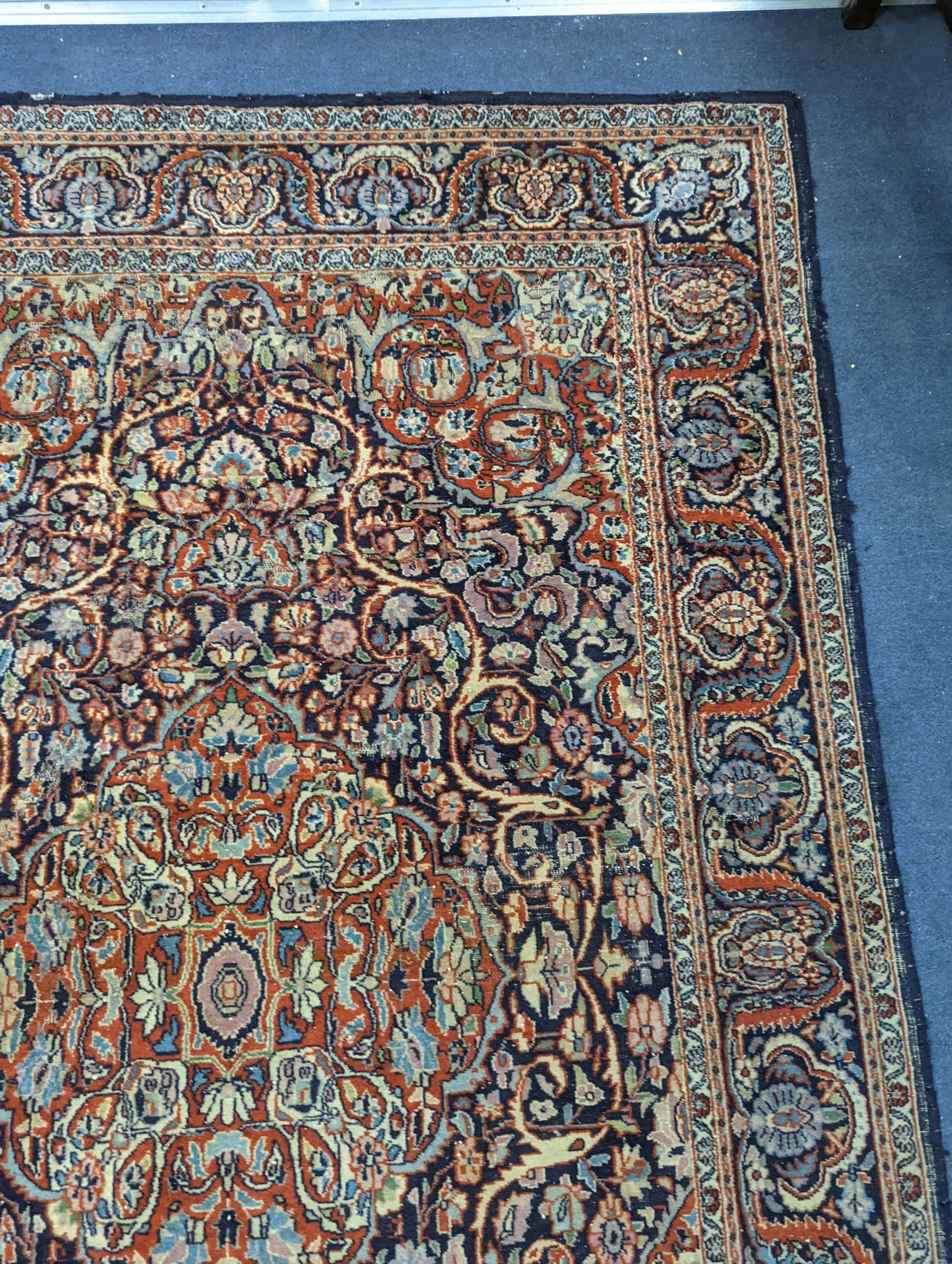 A Kashan blue ground rug, 185x122cm.